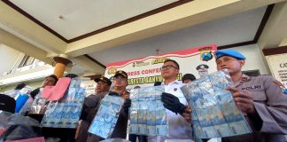 Kapolresta Banyuwangi Kombespol Deddy Foury Millewa menunjukkan barang bukti uang hasil pembobolan ATM, Rabu (7/5/2023). (foto/udi)