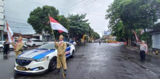 Polisi mengajak pengendara di Banyuwangi menghormat di momen peringatan detik-detik Proklamasi, Kamis (1/8/2023). (foto/udi)