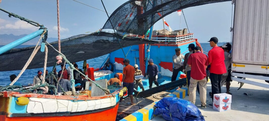 Pekerja sedang menurunkan ikan dari kapal di Banyuwangi, belum lama ini.