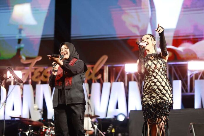 lydora Bupati Banyuwangi Ipuk Fiestiandani berduet dengan Lyodra dalam Festival Musik Tepi Pantai, Senin (16/9/2024) malam. (Foto/Humas Pemkab Banyuwangi)