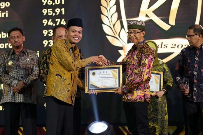 Pj. Sekda Banyuwangi menerima penghargaan dari Komisi Informasi. (Foto/ist)